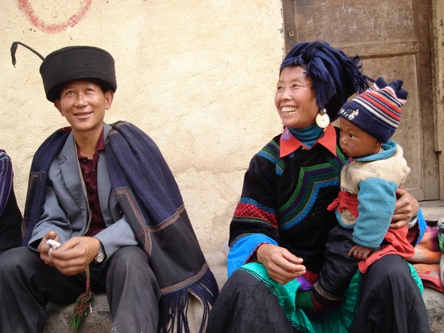 A couple with child relaxes at the local market