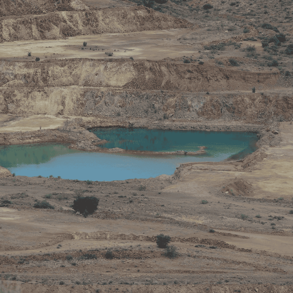 Beautifully polluted turquoise colored pitlake at Copper Flat Mine.