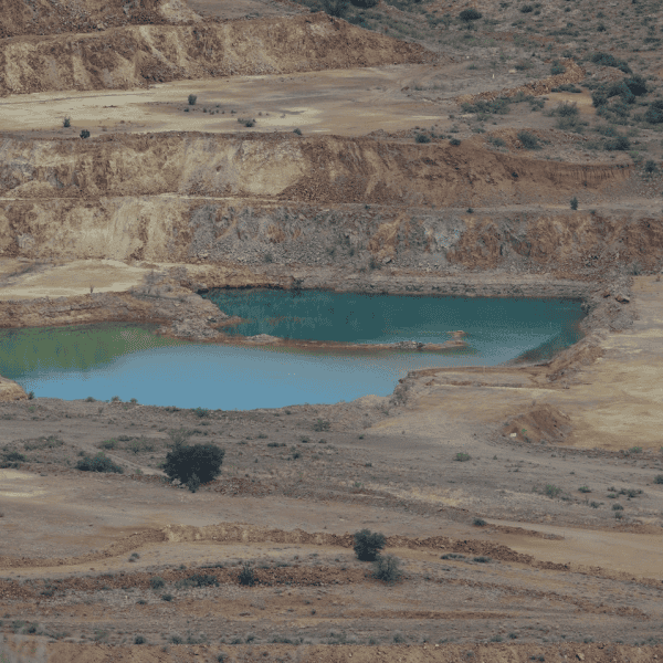 Beautifully polluted turquoise colored pitlake at Copper Flat Mine.