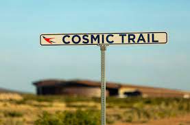Cosmic Trail road sign with Spaceport American terminal in background