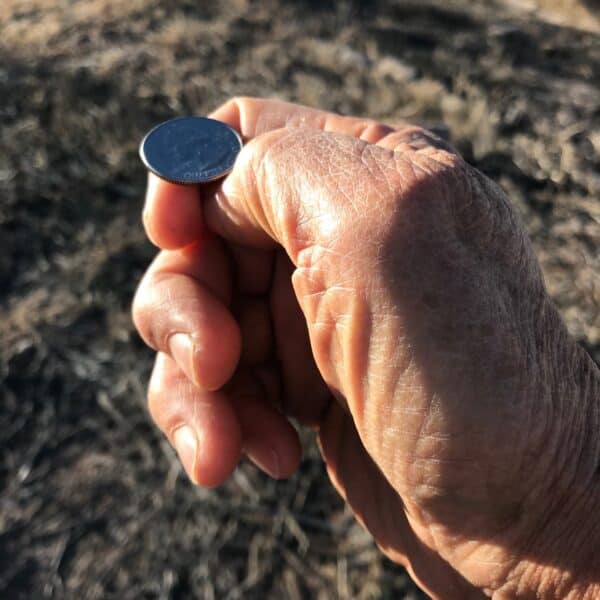 Photograph of hand flipping coin.