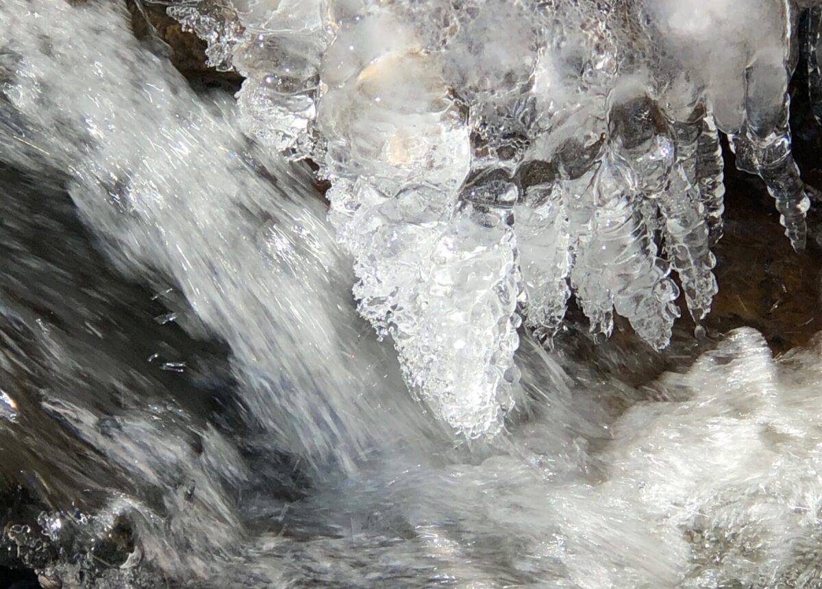 bulbous icicles over rushing water.