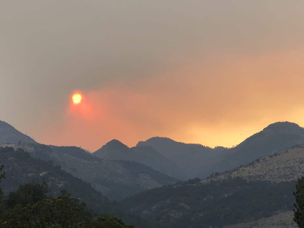 Orange sun in smokey landscape.