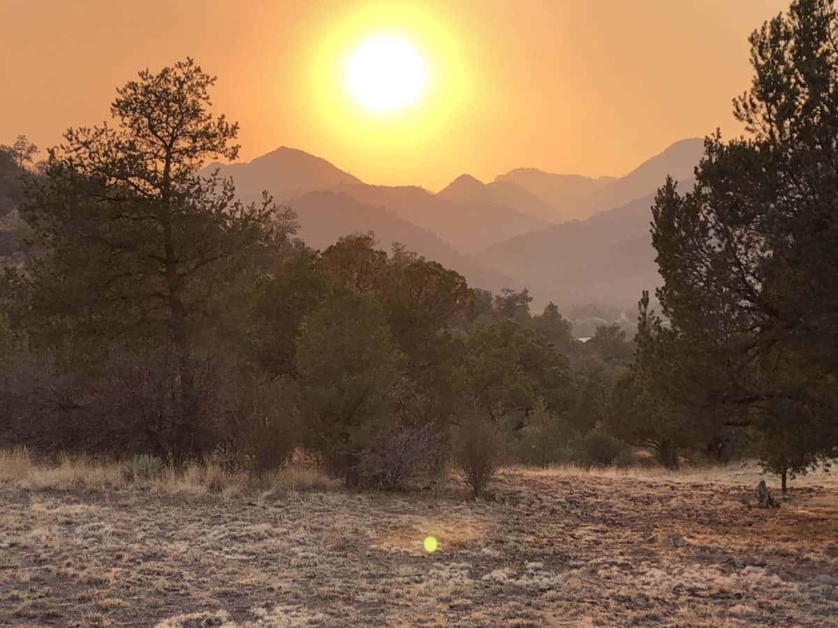 Sun setting in smokey landscape