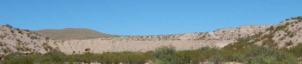 Cantrell Dam, a smallish dirt dam, barely visible between two mesas