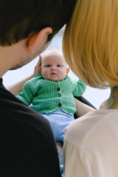 mother and father holding baby