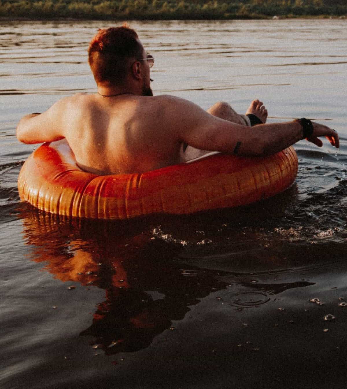 man tubing on a river