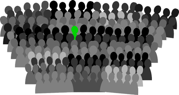 Schematic Image of a lot of people in various shades of gray and one person in green.