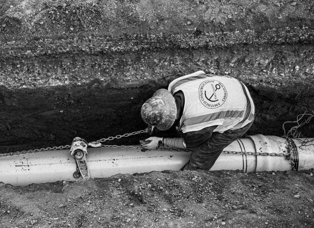 worker fixing a water pipe